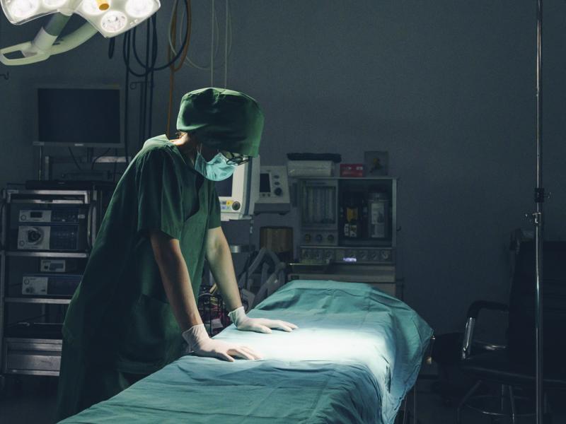 Healthcare worker in empty hospital operating room