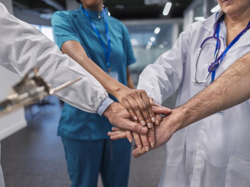 Medical team stacking hands