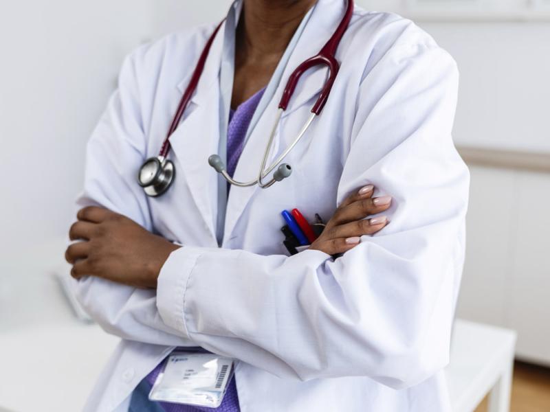 Physician with arms crossed