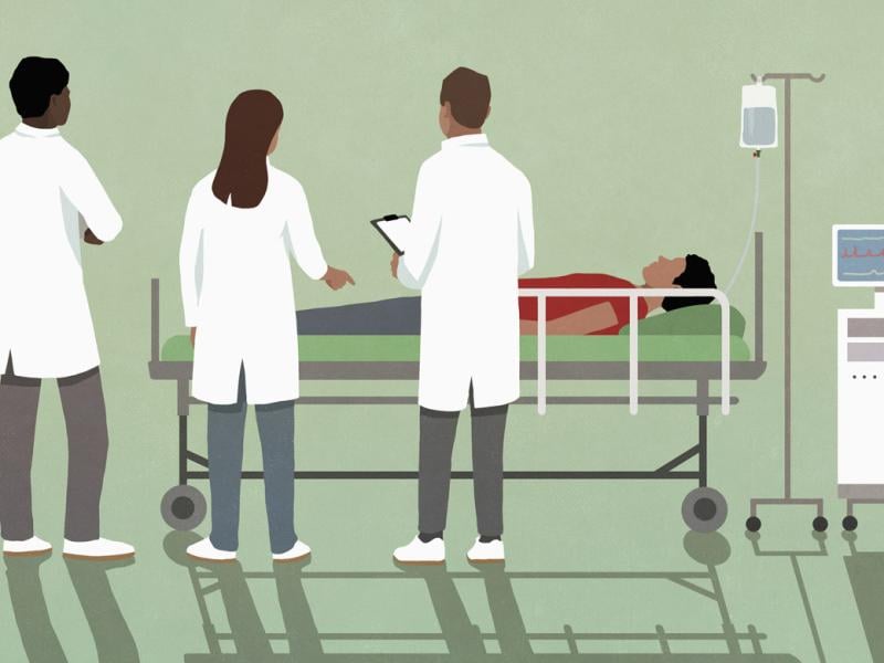 Healthcare figures surround a patient
