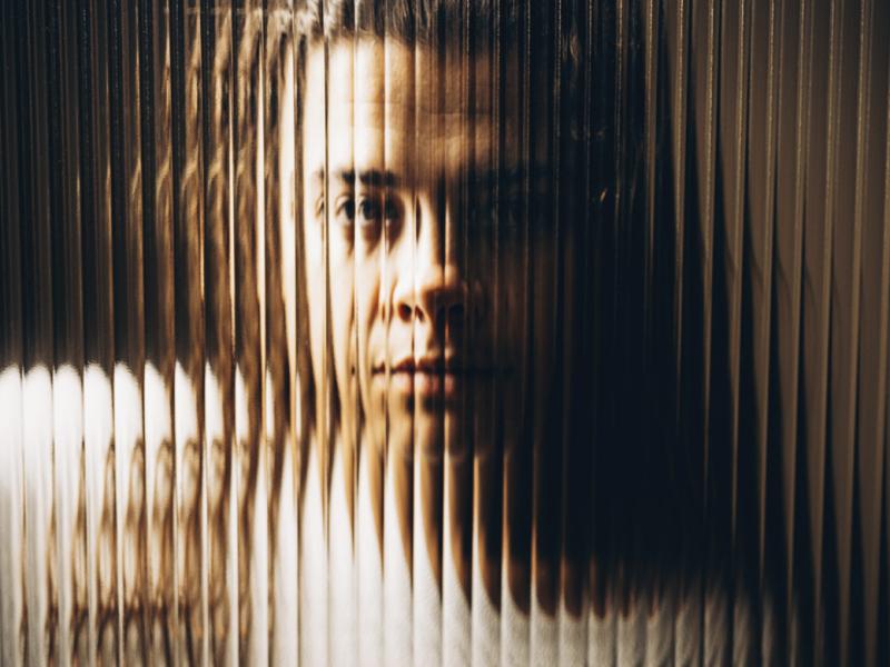 Woman behind textured glass