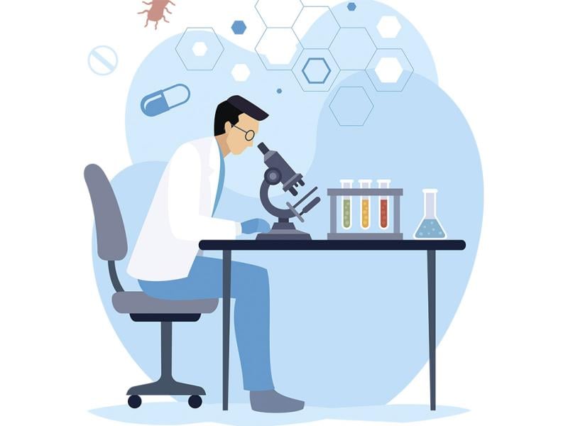 Scientist looking through microscope