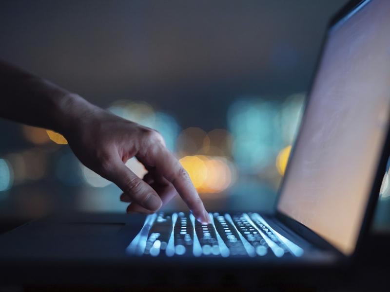 Hand points to laptop