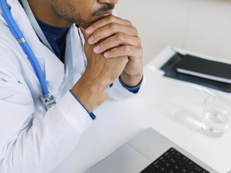 Physician sits at desk