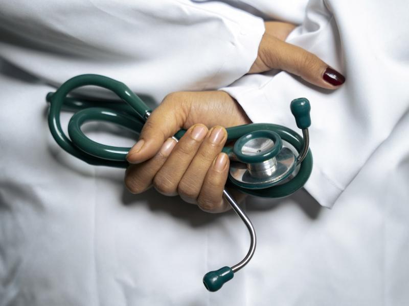 Hand holds stethoscope