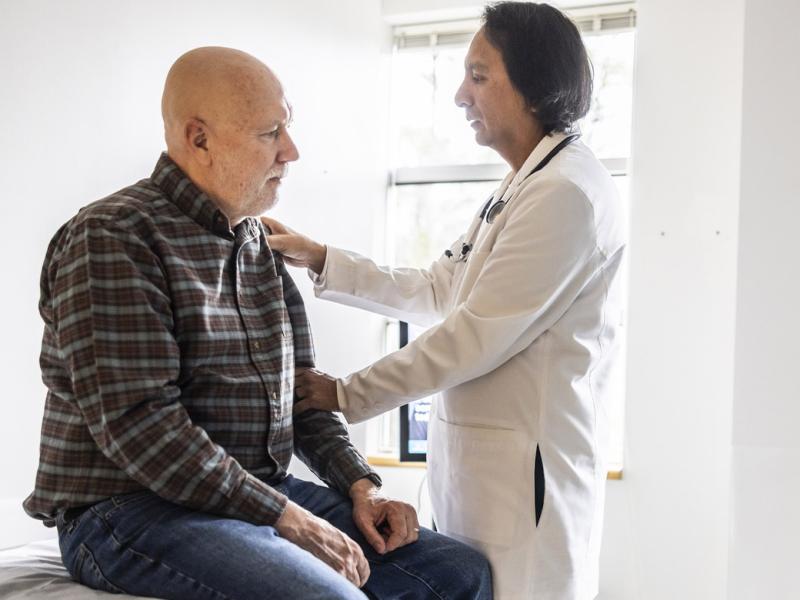 Doctor giving patient a joint exam in doctor's office