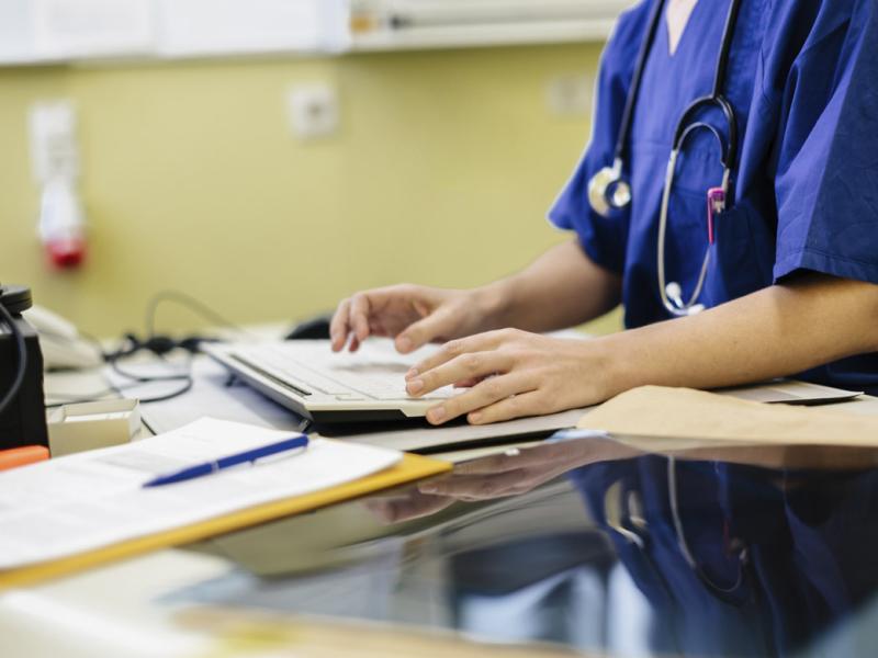 Doctor works at a hospital computer