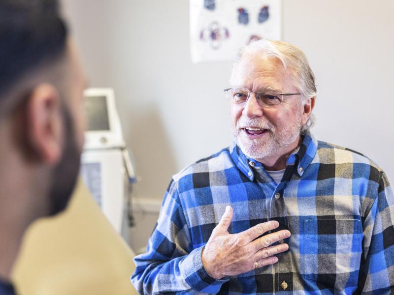 Patient with a hand to chest