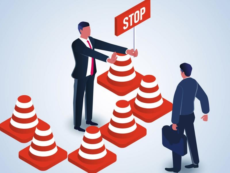 Figure holds a sign with the word stop toward another individual