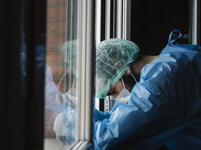 Slumped physician at a window