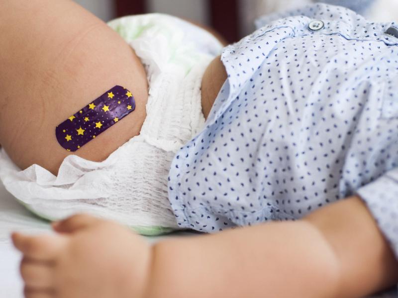 Baby with bandage on upper thigh