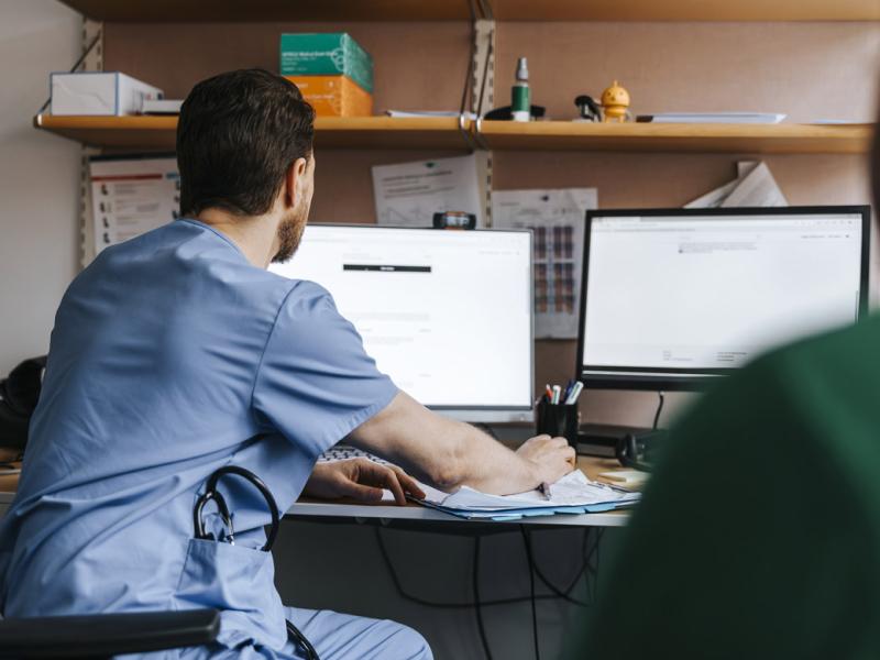Physician checks medical records on computer