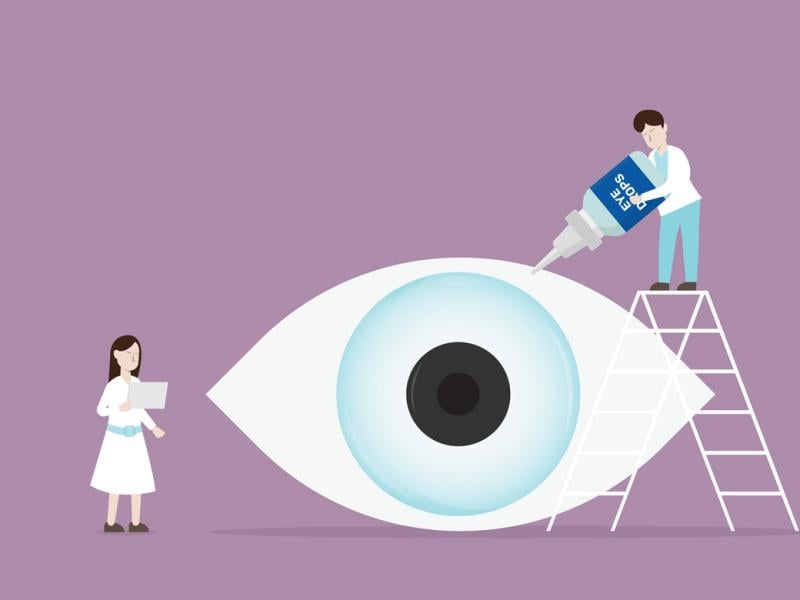 Two figures treat a giant eyeball