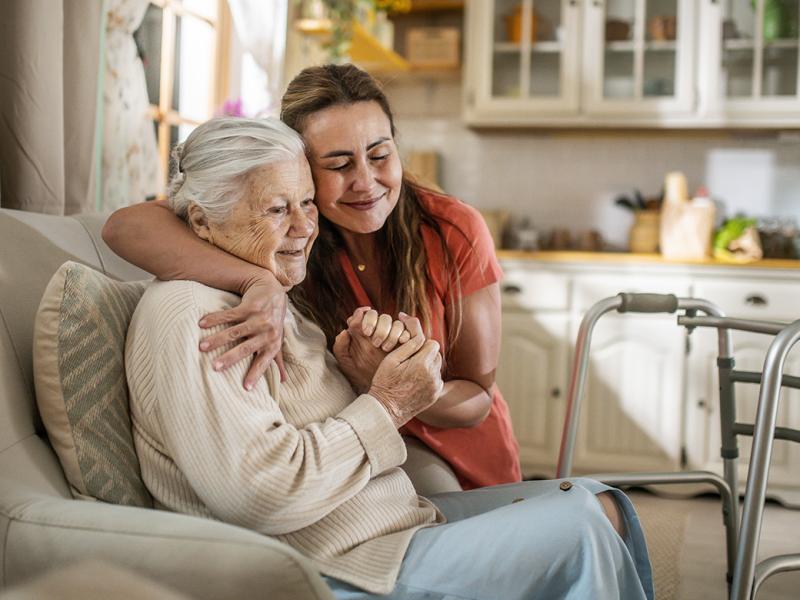 Smiling woman embraces another
