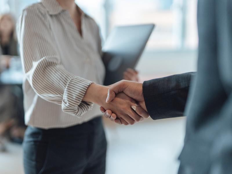 Two people shake hands