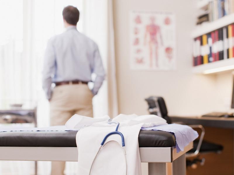 Physician looks out a window