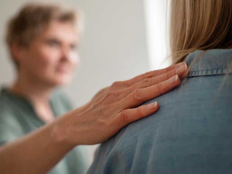 Reassuring hand on shoulder