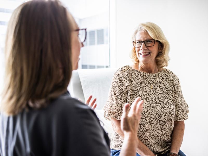 Smiling patient listens to doctor