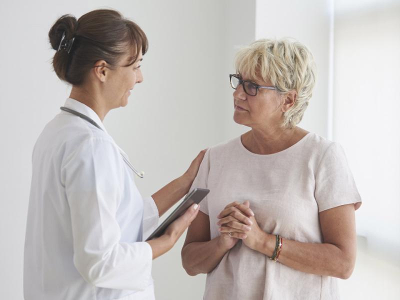 Physician places hand on patient's shoulder