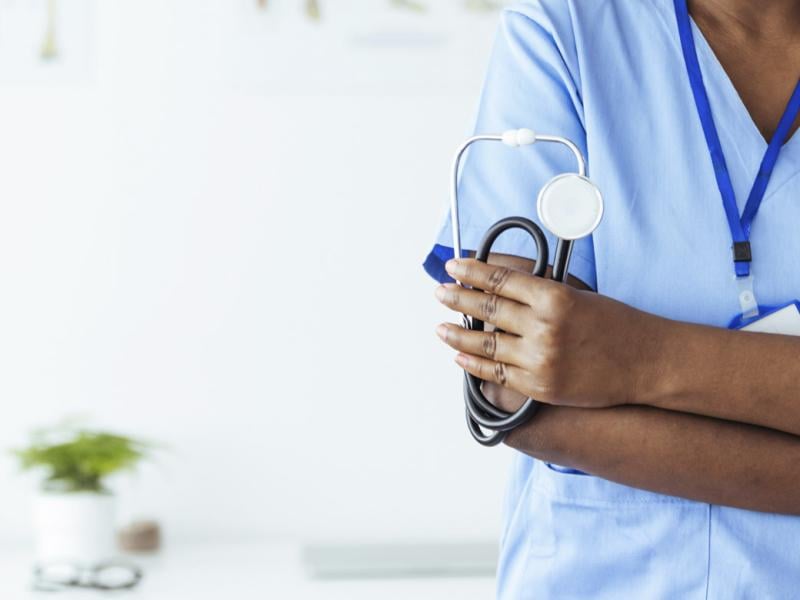 Physician holds stethoscope