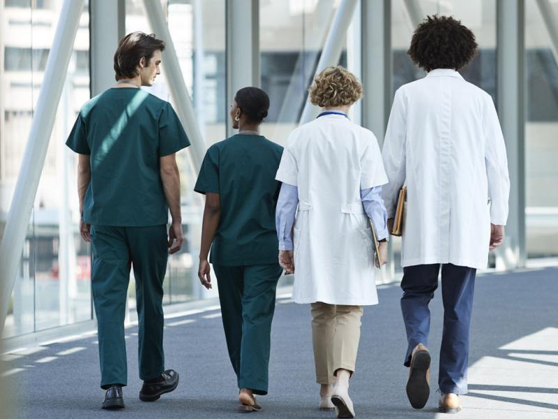Group of physicians walk down a hallway