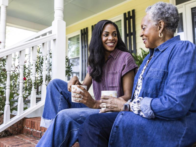 Two people sit on front steps