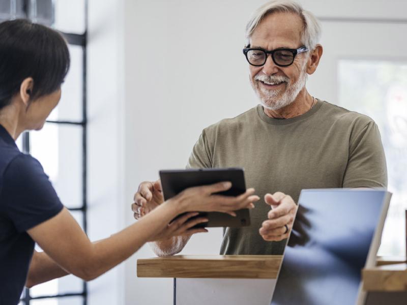 Two people using a tablet