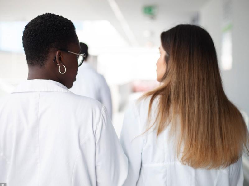 Two healthcare workers in conversation