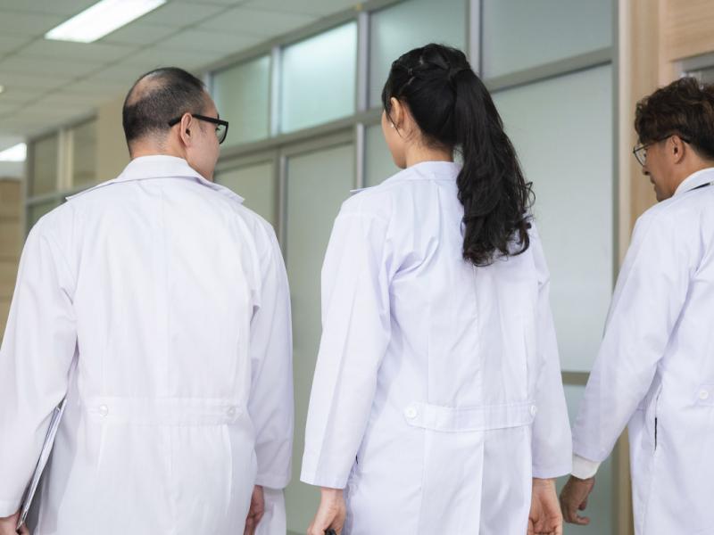 Three physicians in a hallway