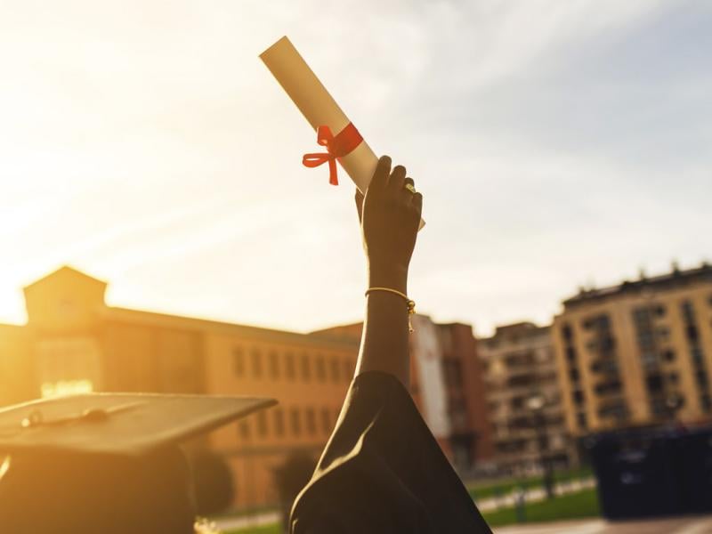 Hand holds a diploma