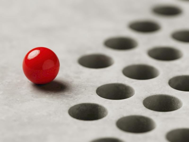 Ball sits before a series of holes