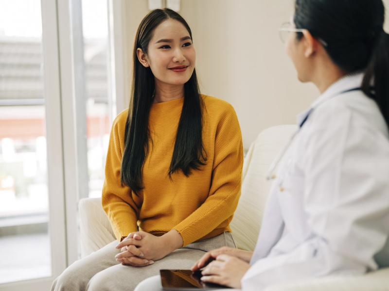 Smiling patient looks at physician during appointment
