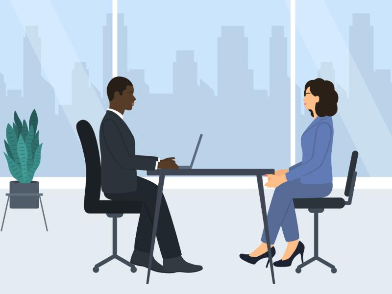 Two businesspeople at a table in an office