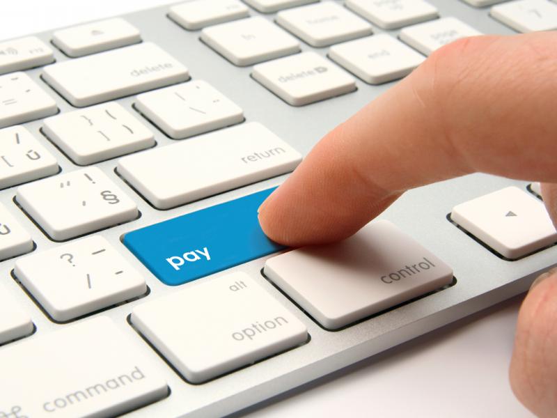 Computer keys with highlighted pay button (tight shot)