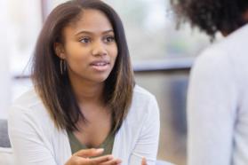 Young woman talking with physician