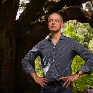Photo of Nigel Girgrah, MD, standing in front of a tree