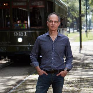 Photo of Nigel Girgrah, MD, standing in front of a street car.