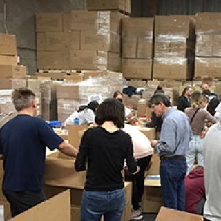 Ukrainian Medical Association of North America volunteers in Illinois pack boxes of medical supplies for Ukraine.