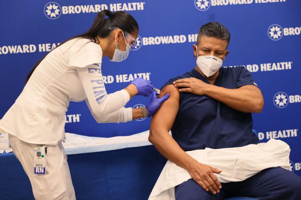 Person receiving COVID-19 vaccine