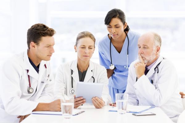 Medical Staff surrounding an iPad