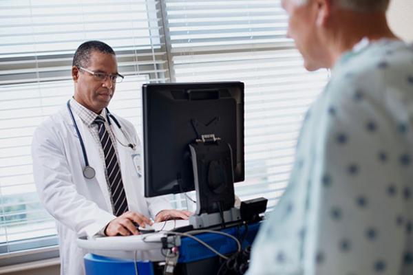Doctor with computer consulting with patient