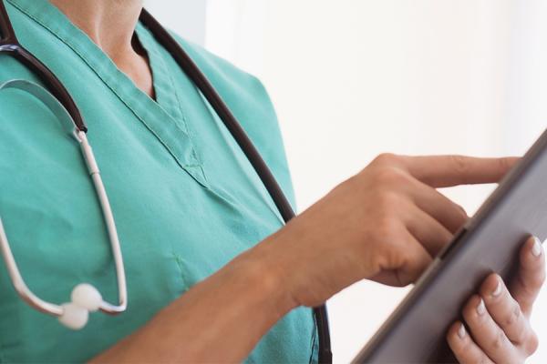 Close up of a physician using her tablet.