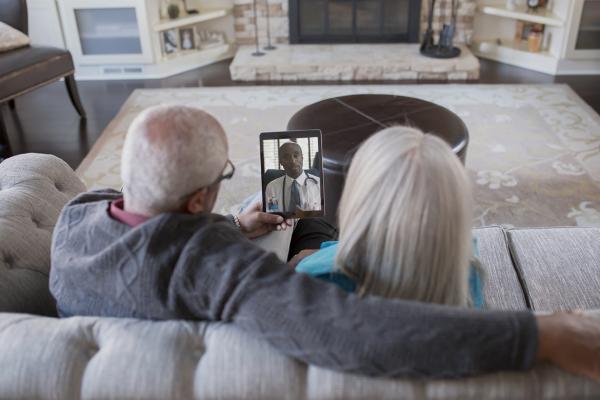 Couple has virtual visit from doctor in their home.
