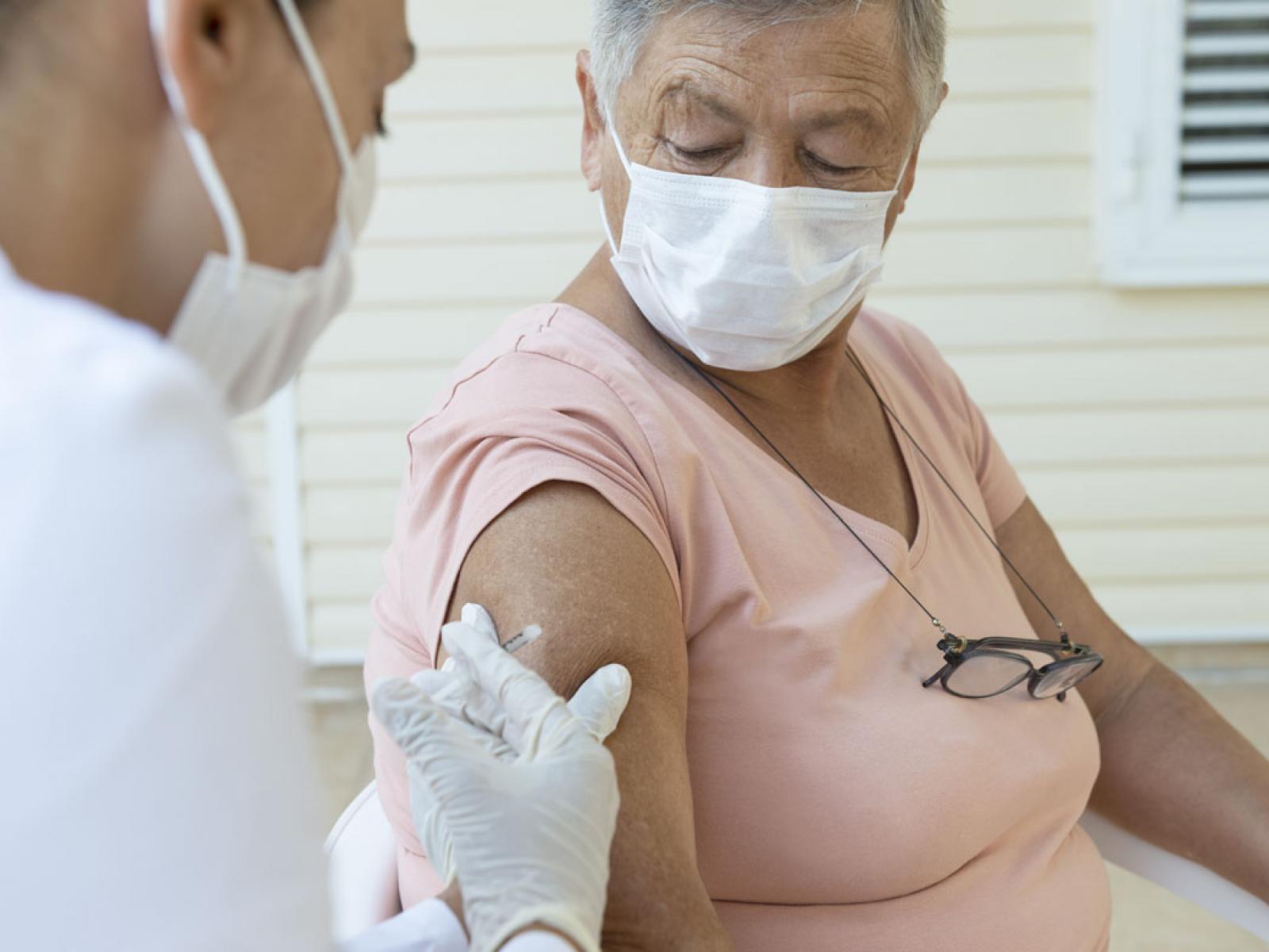 Person receiving a vaccine.