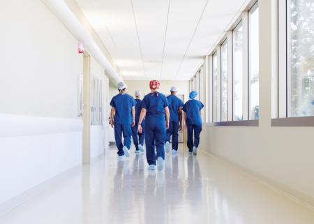 Physician team walking down a hospital hallway