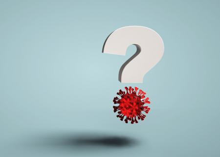 Question mark with illustration of COVID-19 virus floating in the air.