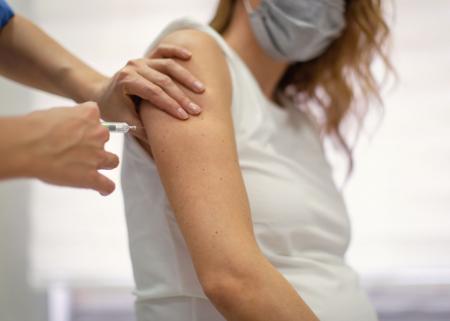 Pregnant person receiving vaccine