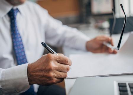 Person's hand with glasses
