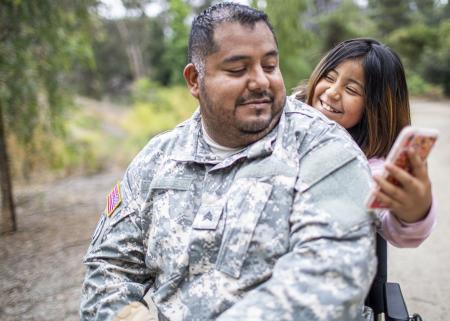 Smiling child showing a parent their smartphone