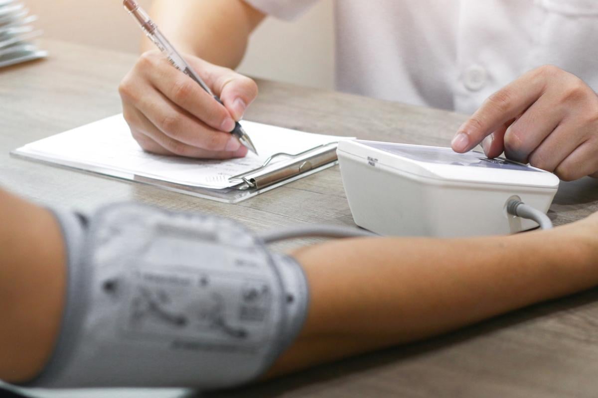 A physician taking a patient's blood pressure.